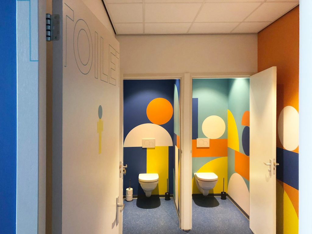 2 toiletten met wallcover en toilet signing